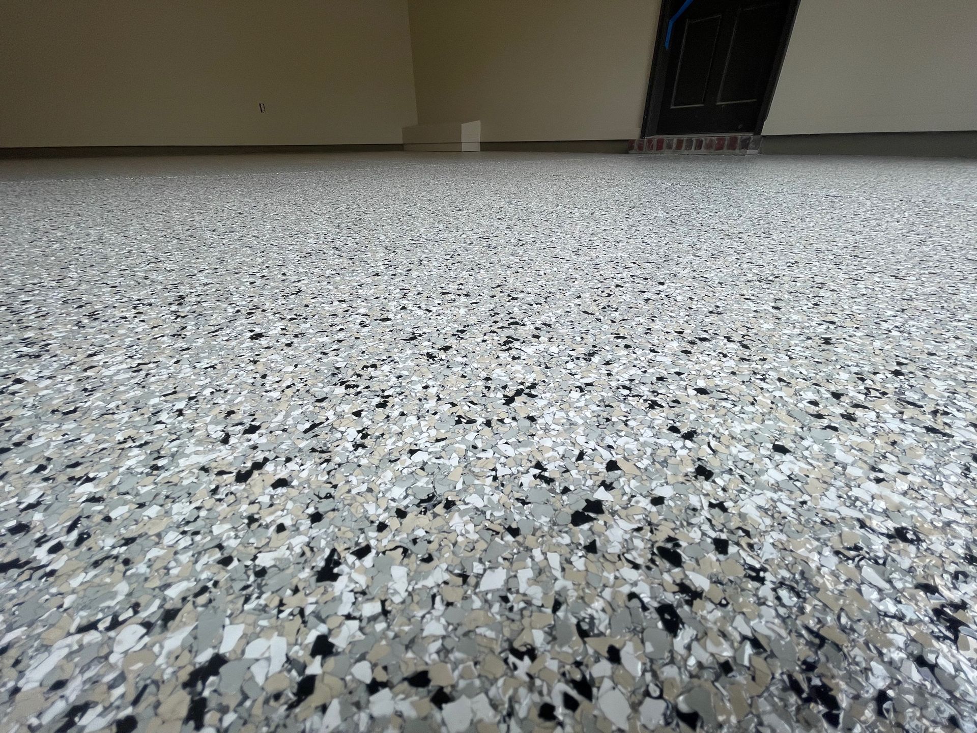 A close up of a gray and black marble floor in a garage.