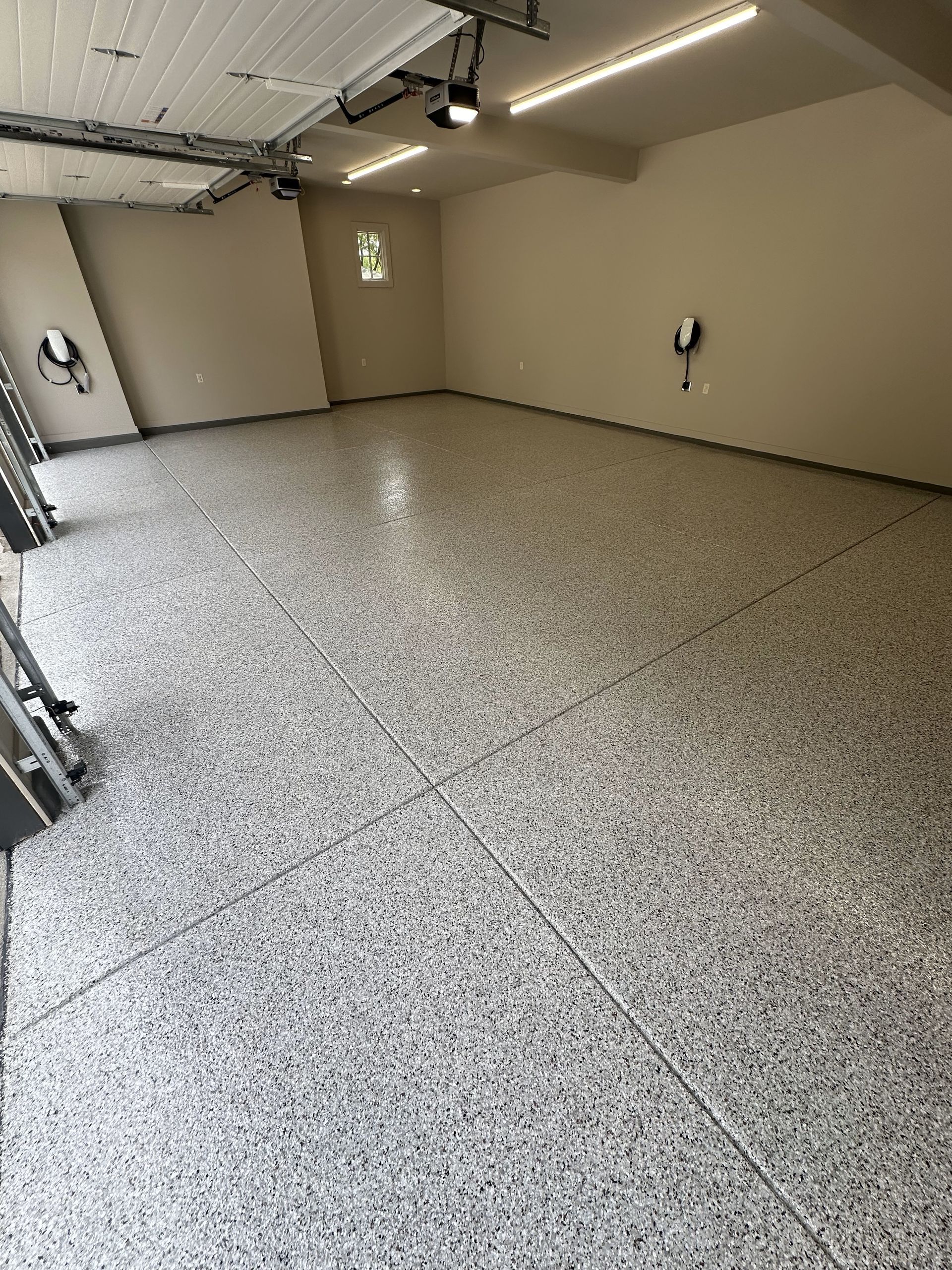 A garage with a concrete floor and a garage door.
