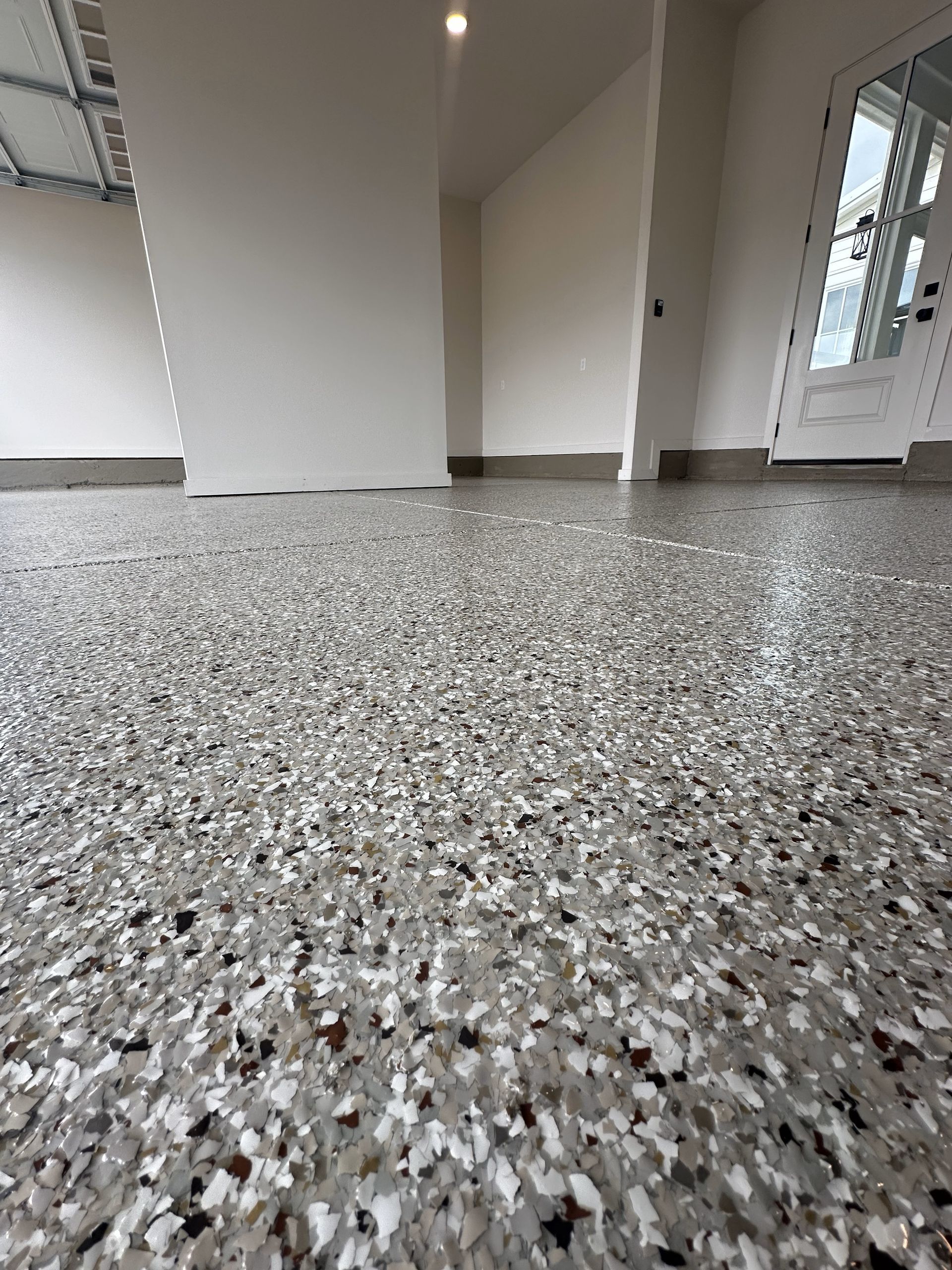 A garage floor with a lot of small rocks on it.