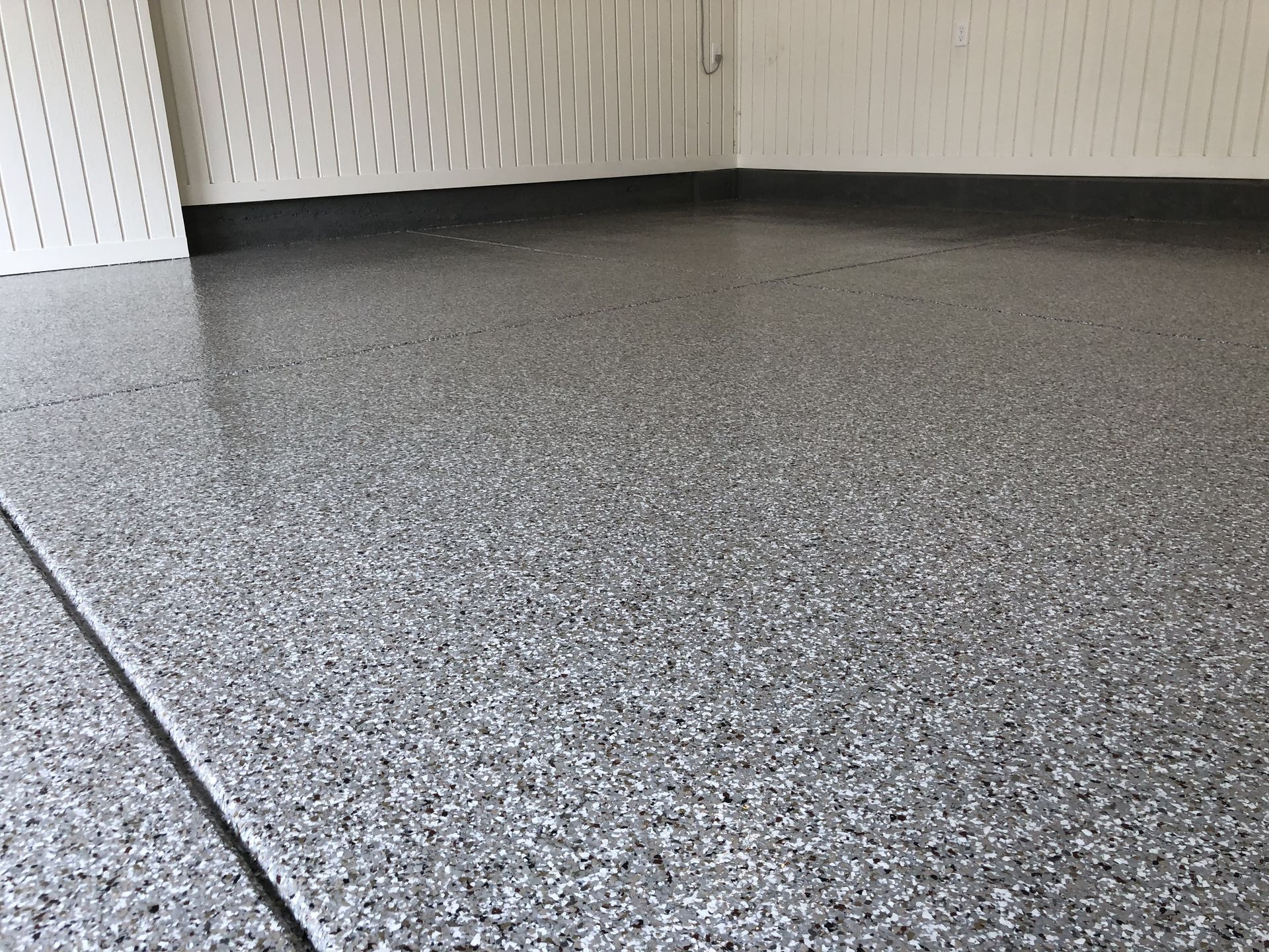 A close up of a gray concrete floor in a garage.