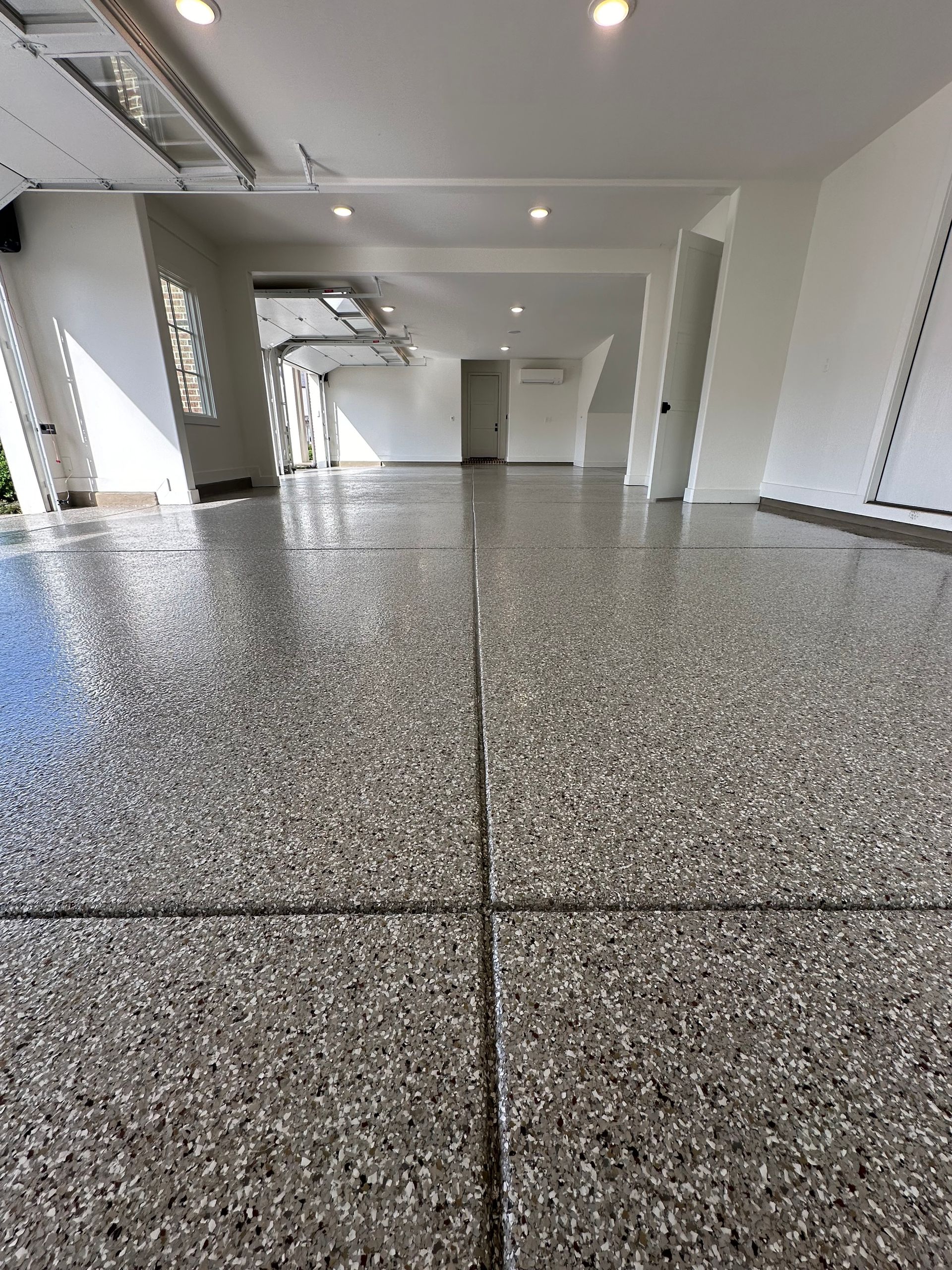 A garage with a gray floor and white walls.