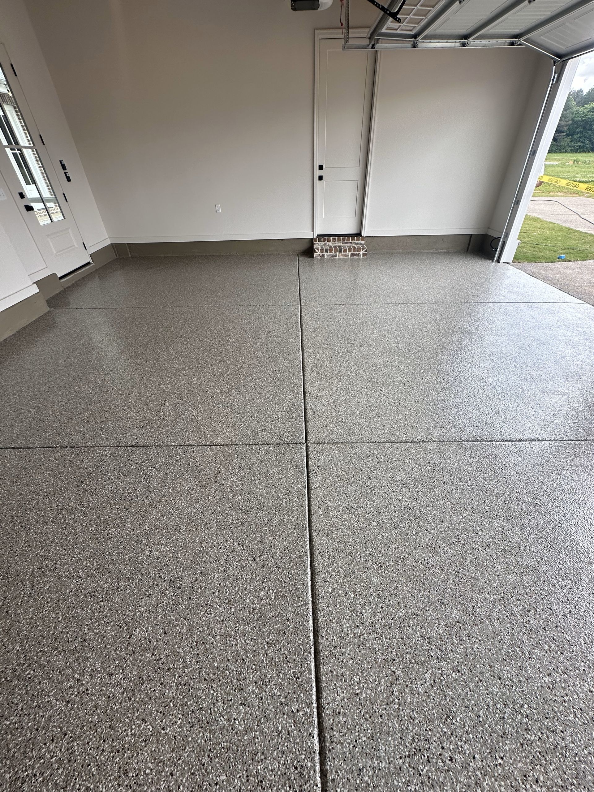 A garage with a concrete floor and a garage door.