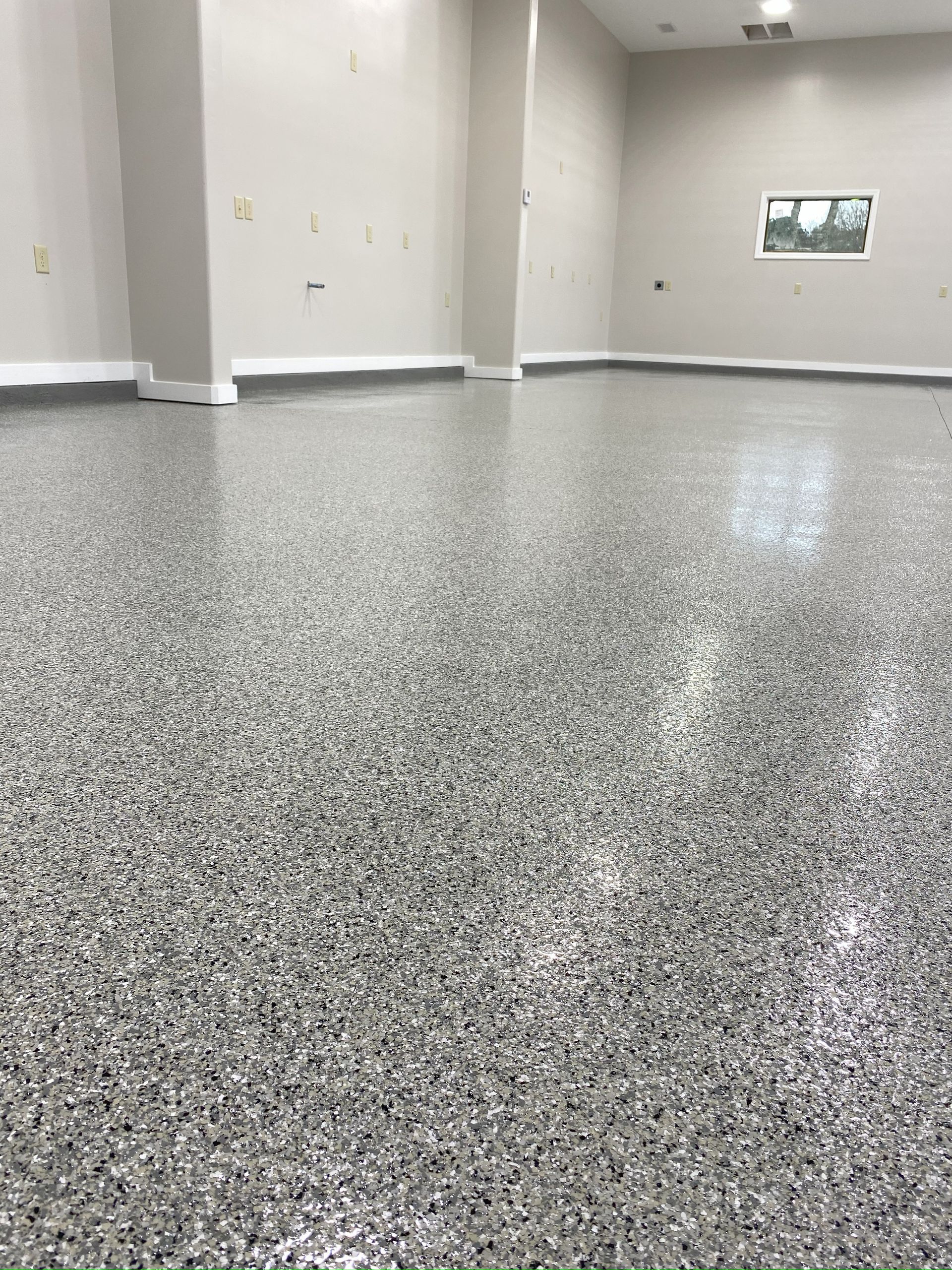 A large room with a gray floor and white walls.