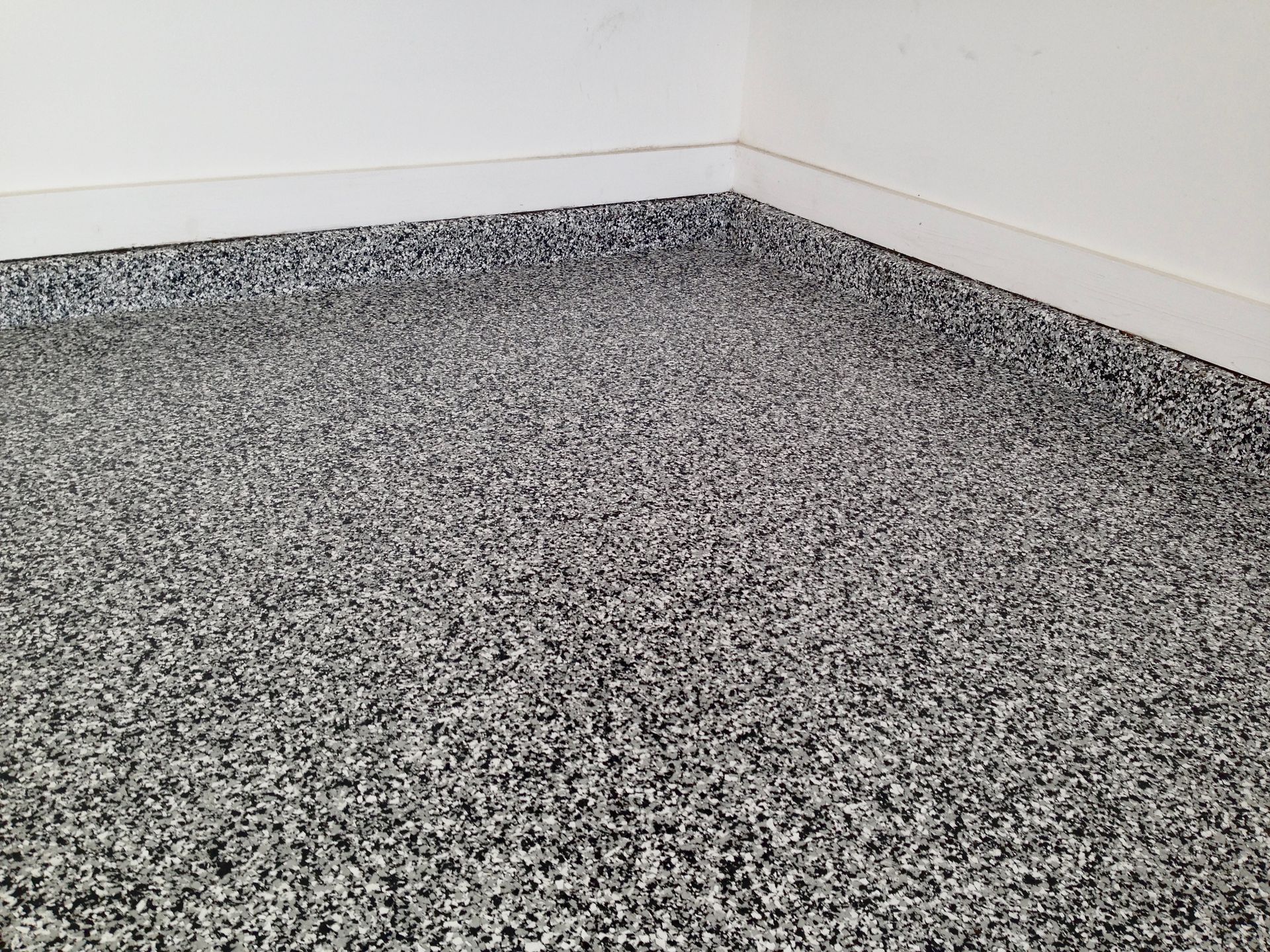 A close up of a gray carpeted floor in a room.