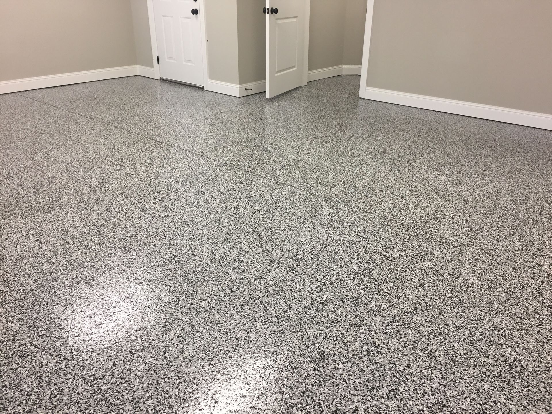 A room with a gray floor and white walls.