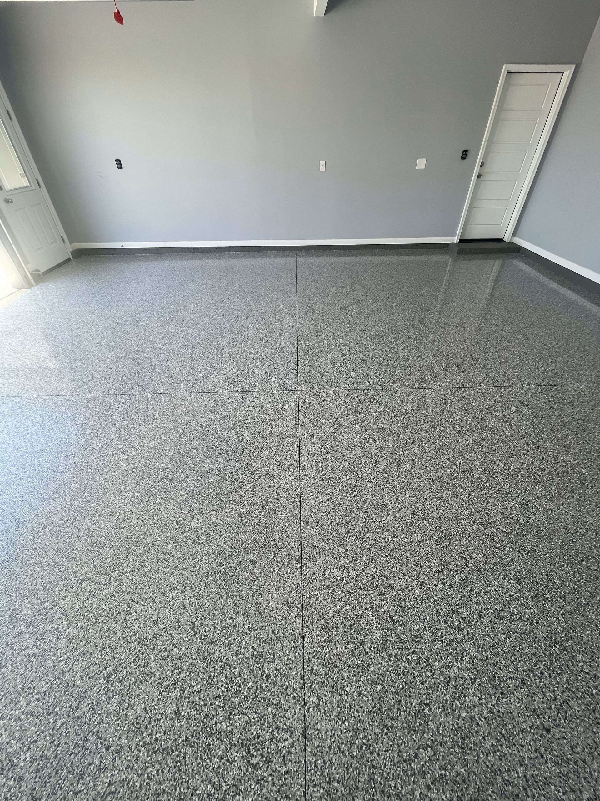 A garage with a gray floor and gray walls.