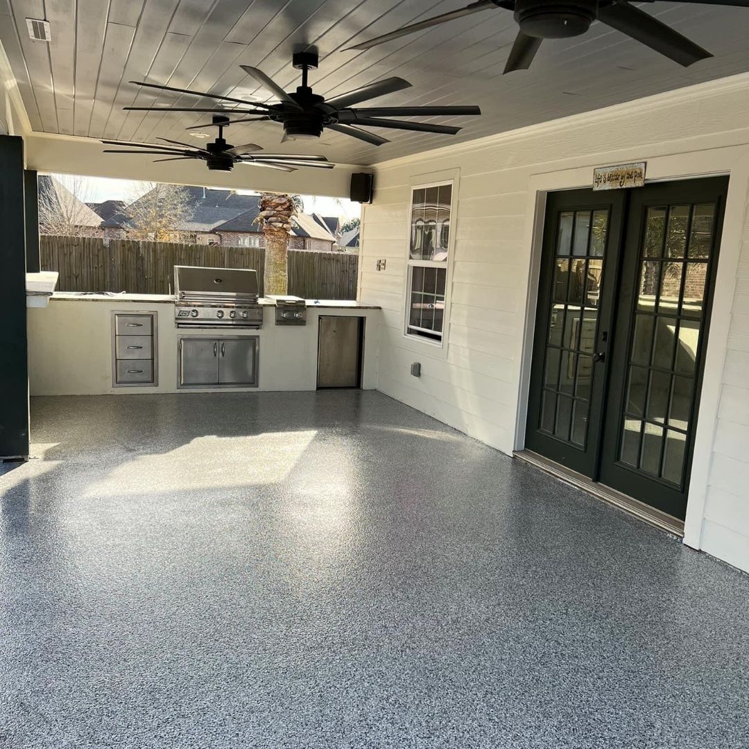 A large room with a ceiling fan and a grill