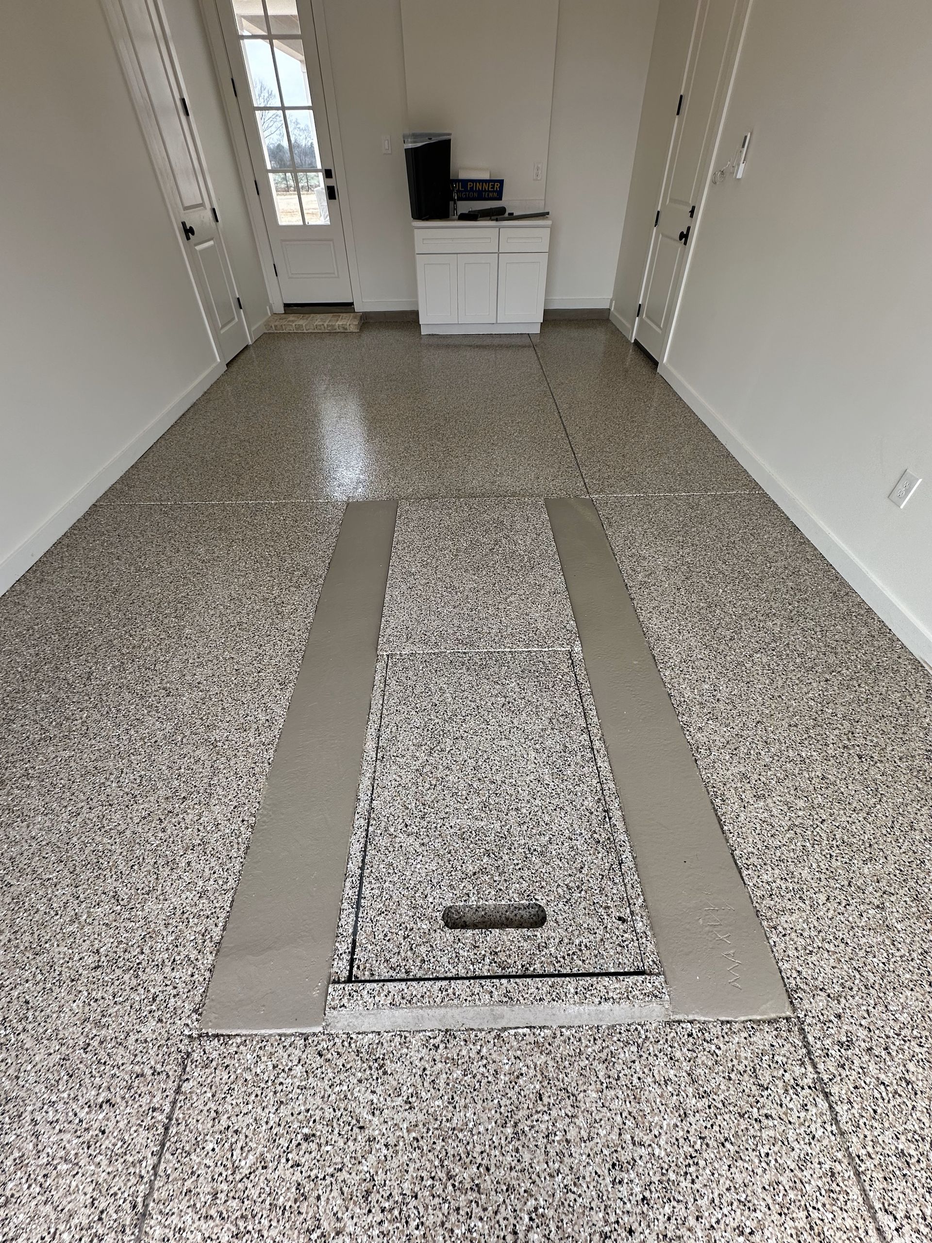 A large room with a marble floor and white walls.