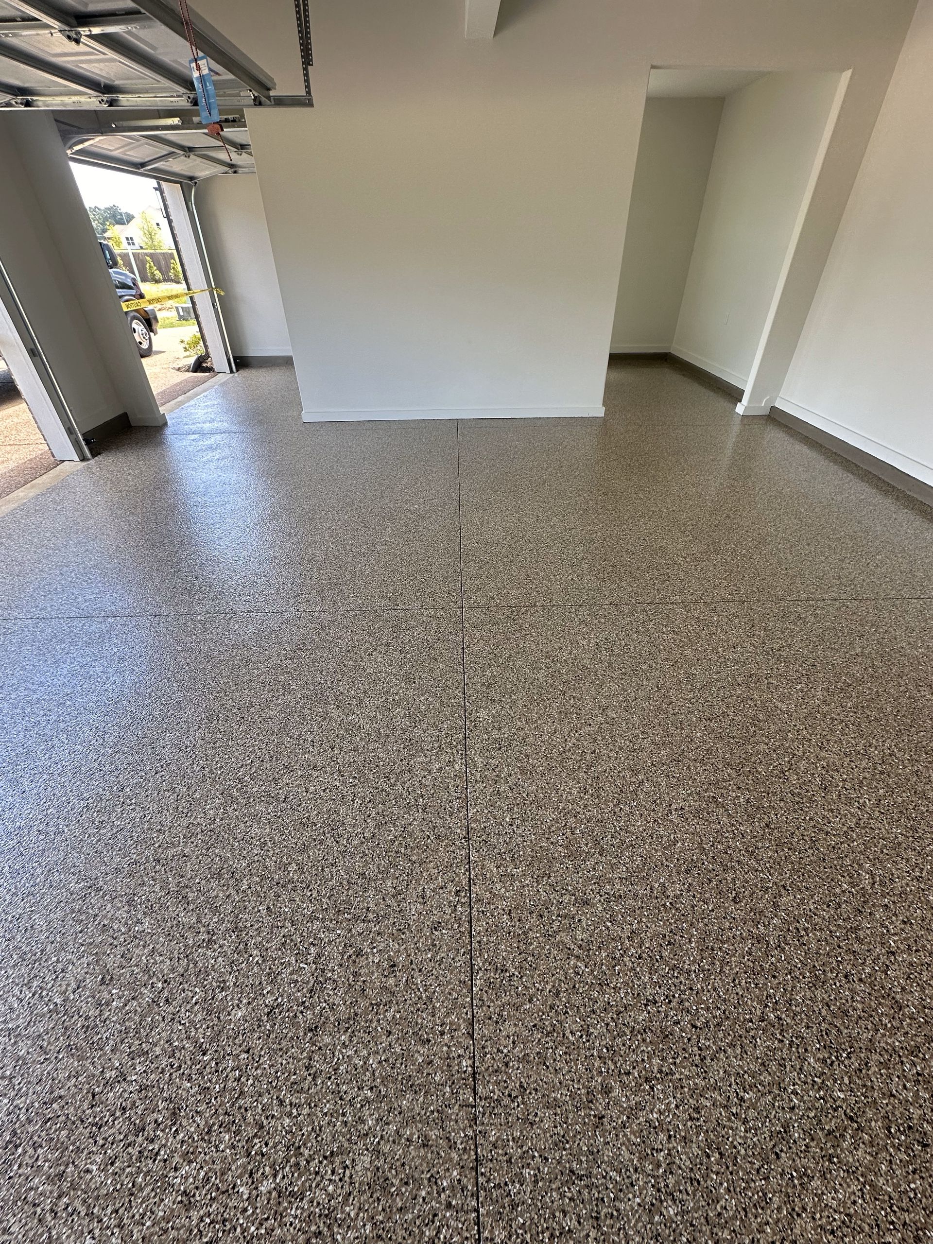 A garage with a concrete floor and white walls.