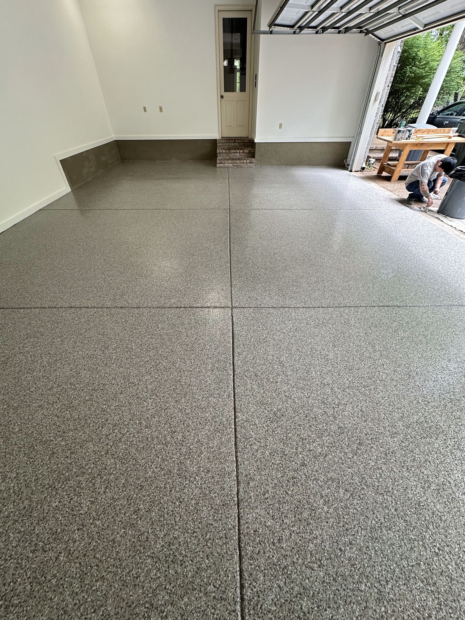 A garage with a concrete floor and a door.