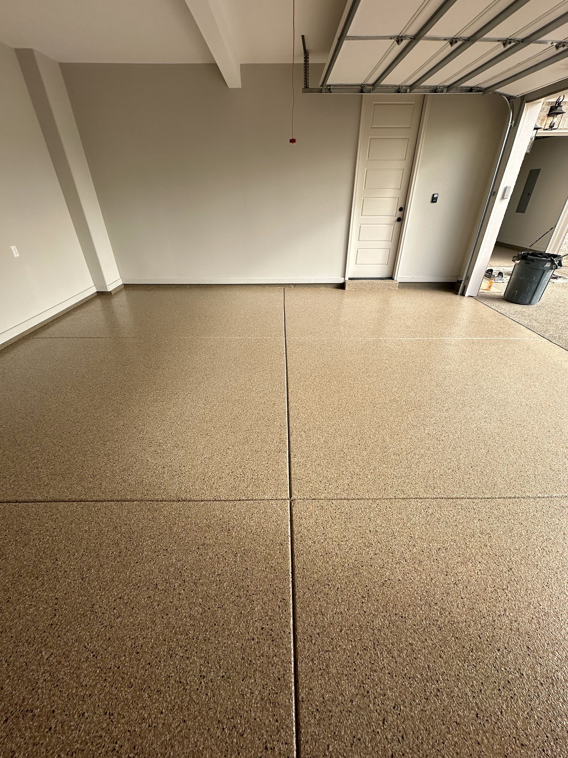 A garage with a concrete floor and a door.