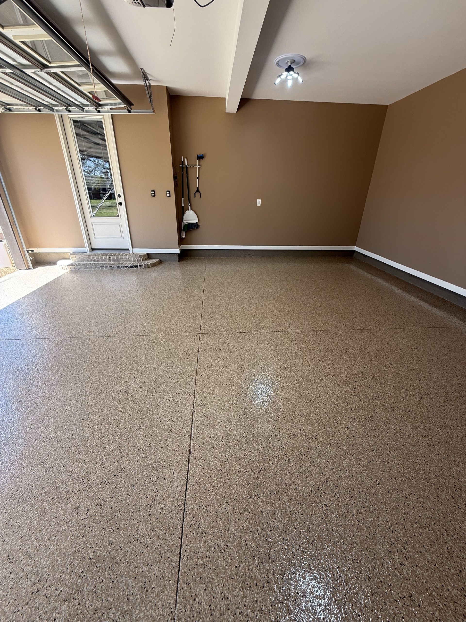 A garage with a concrete floor and a garage door.