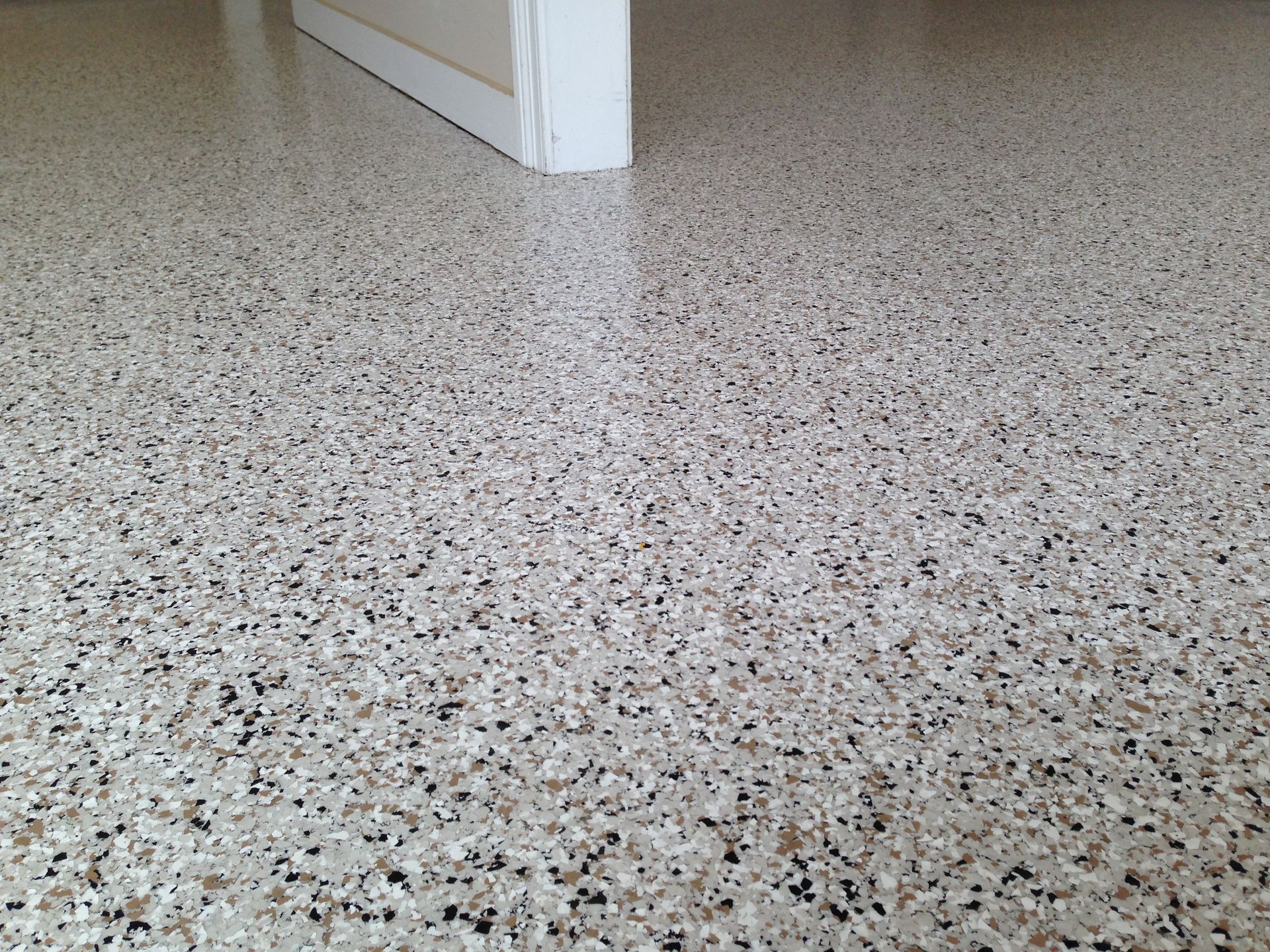 A close up of a floor with a door in the background