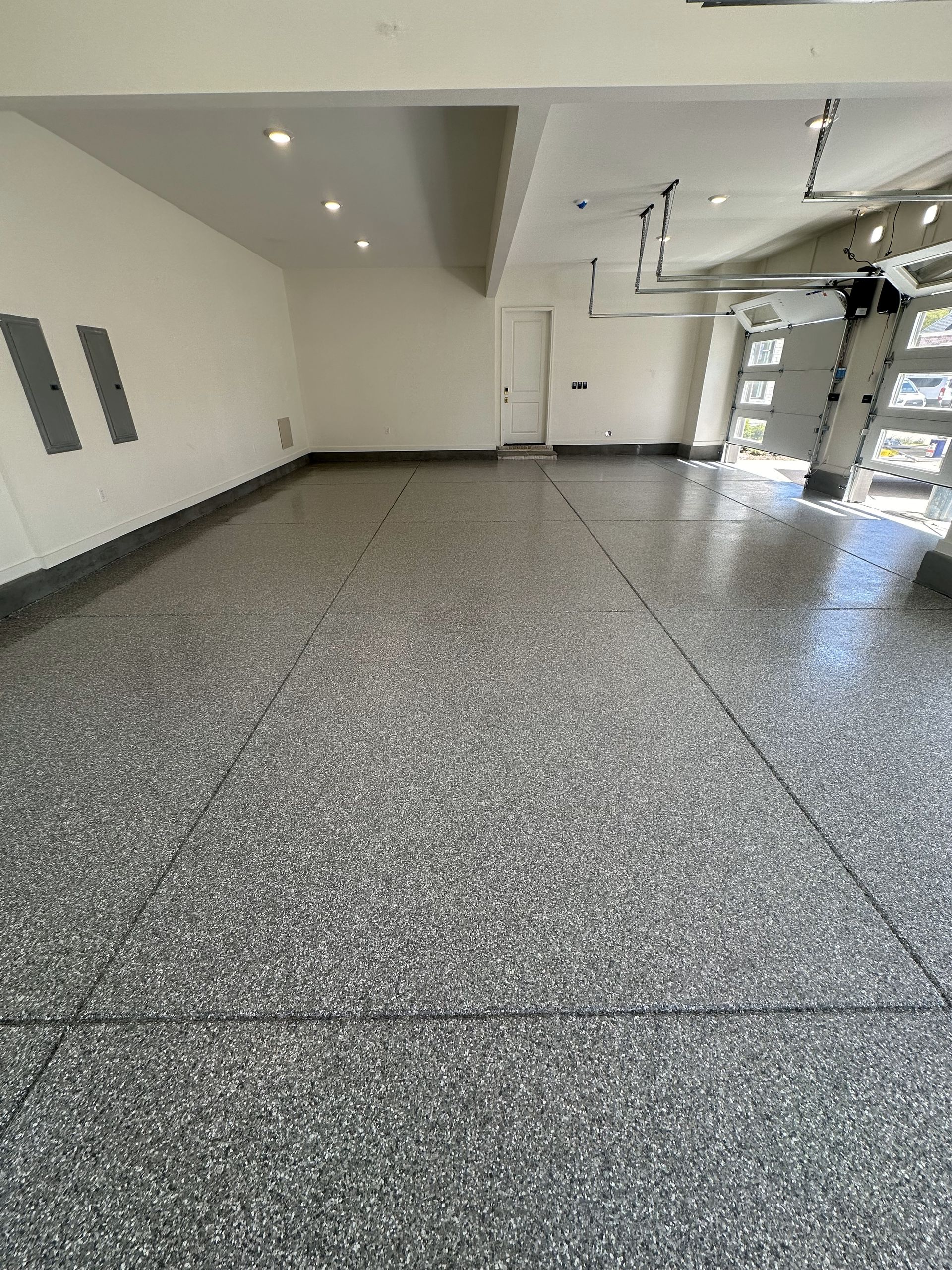A garage with a gray floor and white walls.