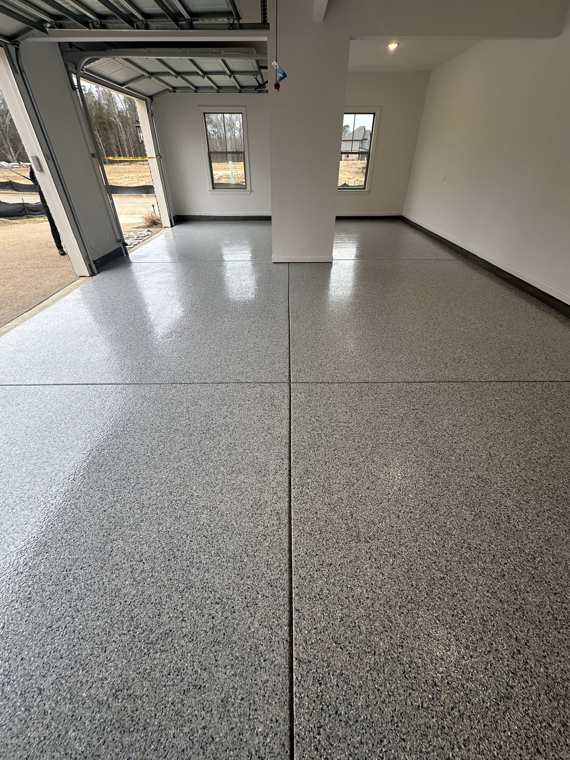 A garage with a concrete floor and a garage door.