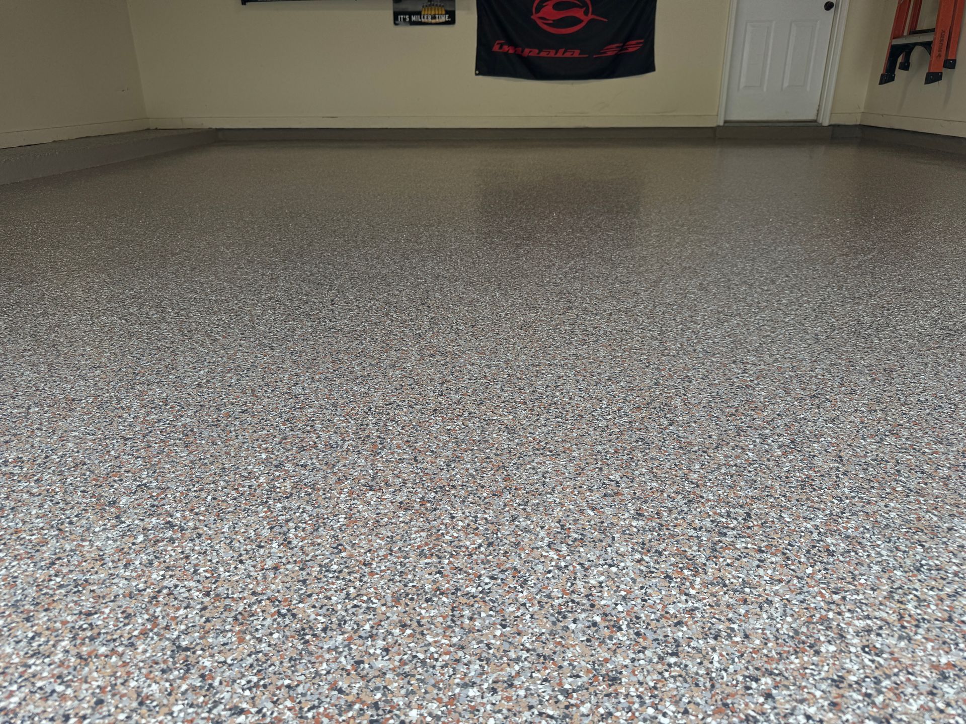 A garage floor with a flag on the wall.
