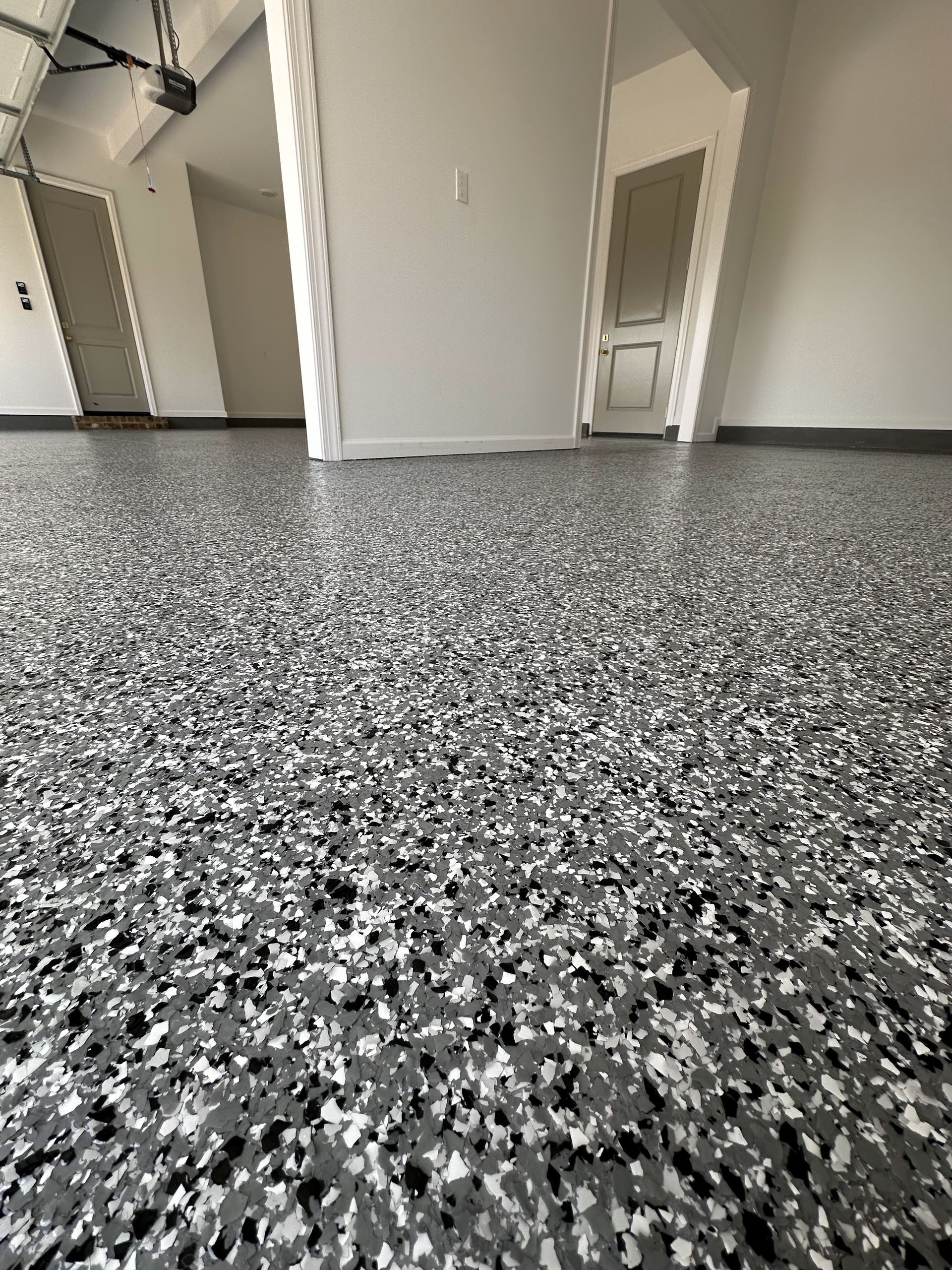 A close up of a gray and white floor in a garage.