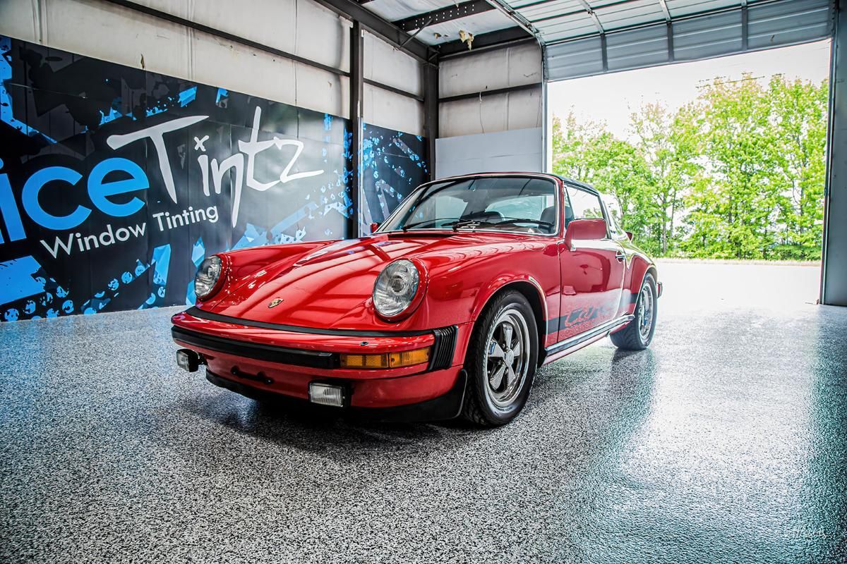 Red sports car in a window tinting shop with epoxy garage floor