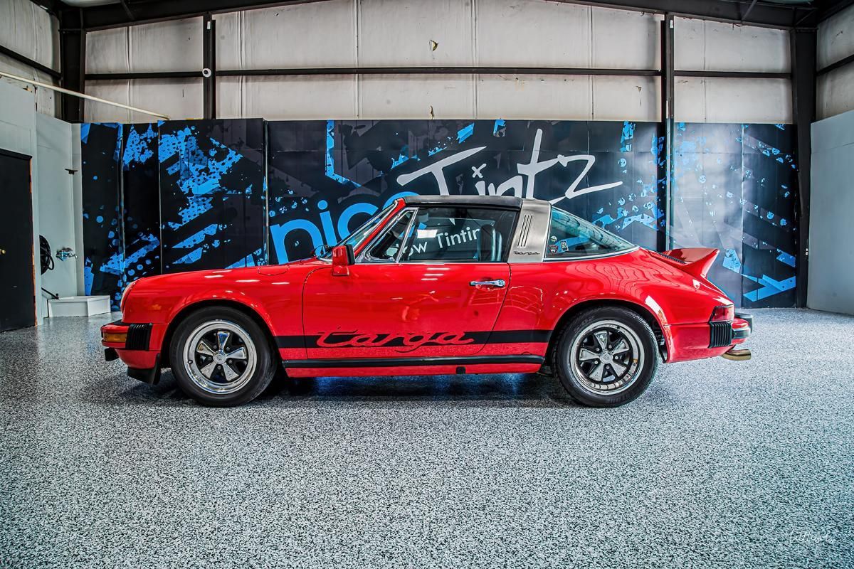 Red sports car in a window tinting shop with epoxy garage floor