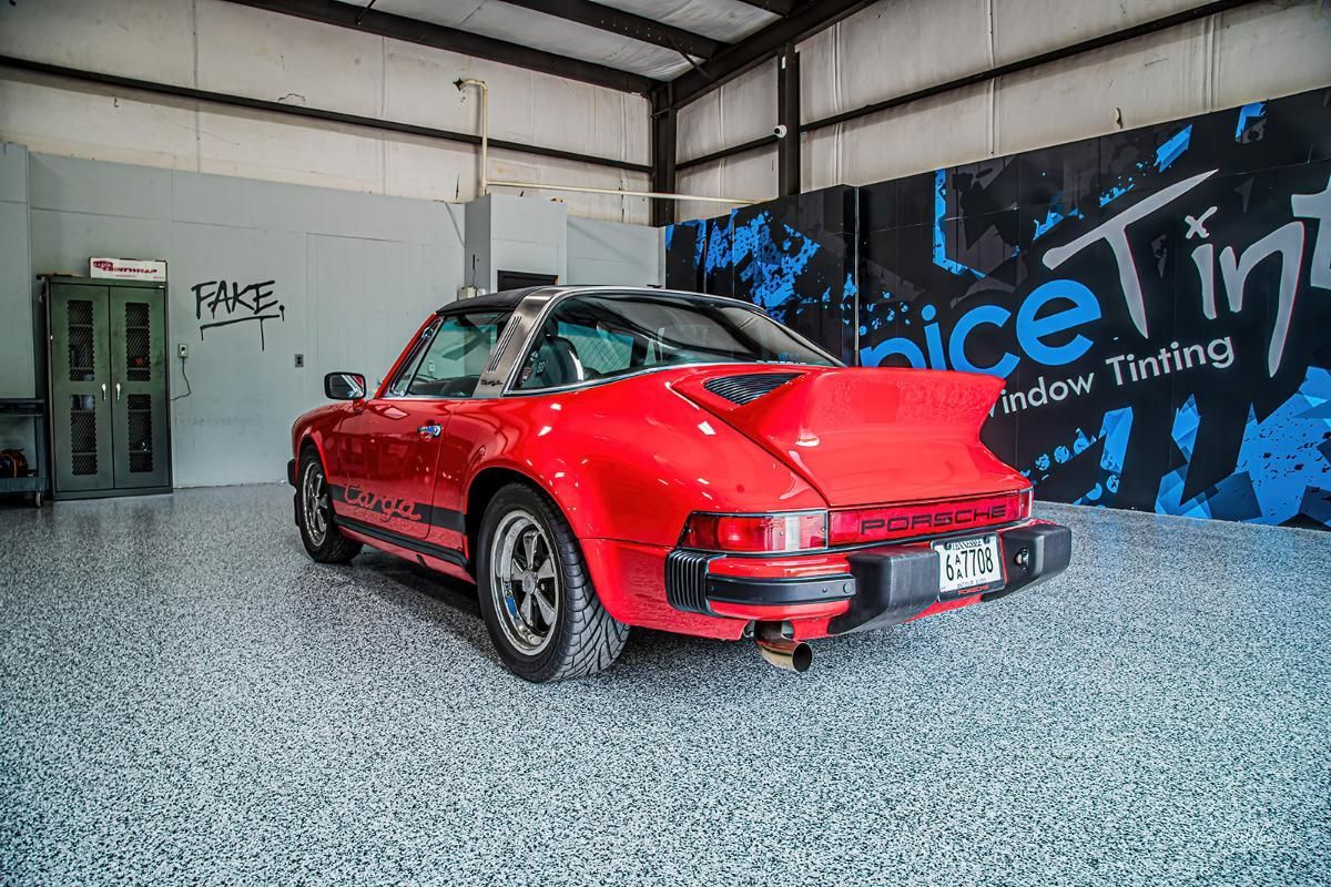 Red sports car in a window tinting shop with epoxy garage floor