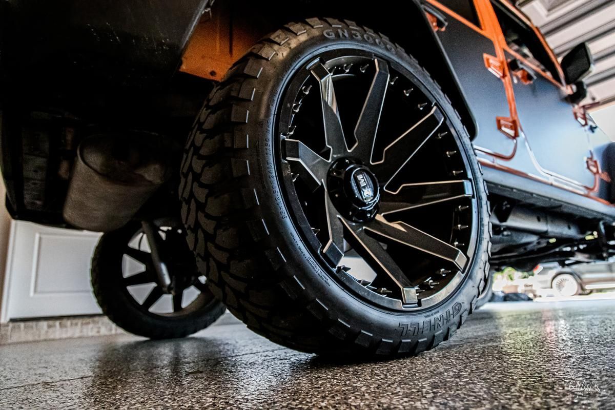 Orange 4x4 in a garage with epoxy garage floor