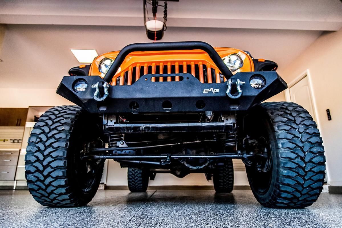 Orange 4x4 in a garage with epoxy garage floor