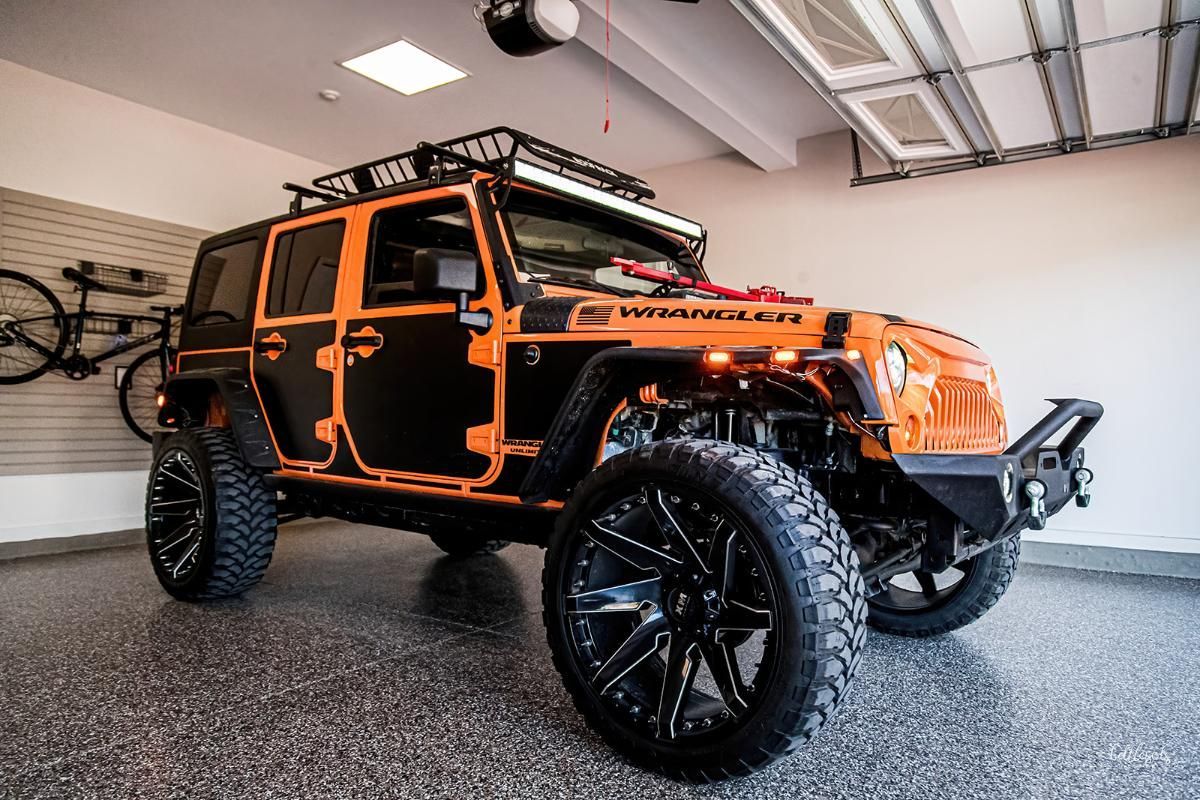 Orange 4x4 in a garage with epoxy garage floor