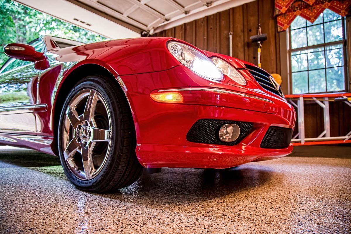 Red luxury car in a garage with epoxy garage floor