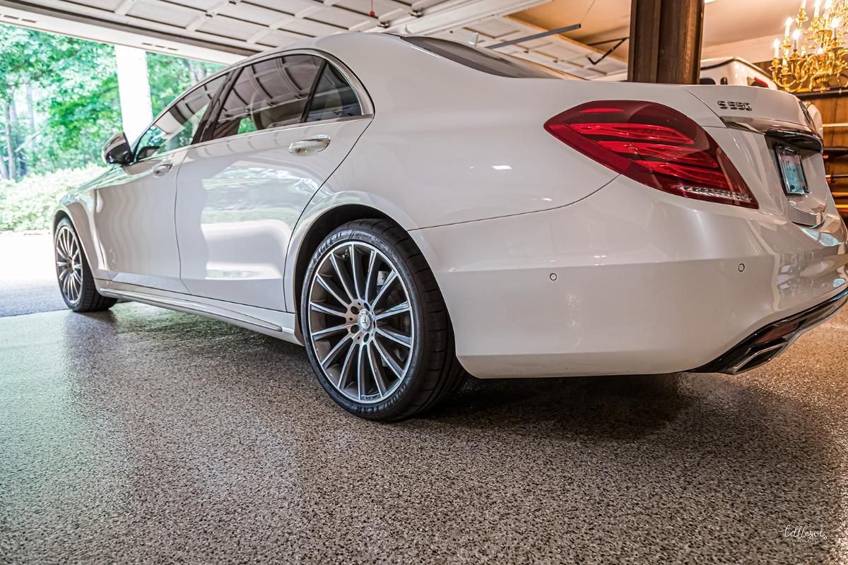 White luxury car in a garage with epoxy garage floor