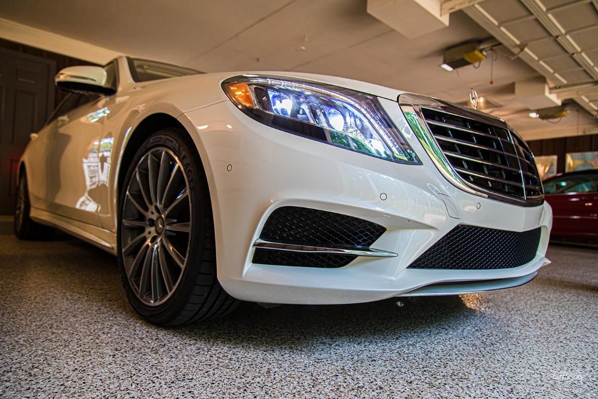 White luxury car in a garage with epoxy garage floor