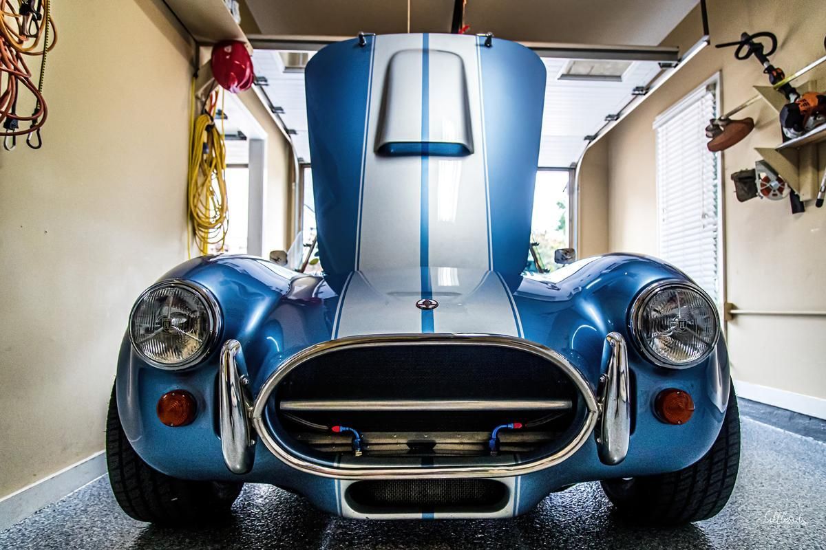 Blue classic car in a garage with epoxy garage floor