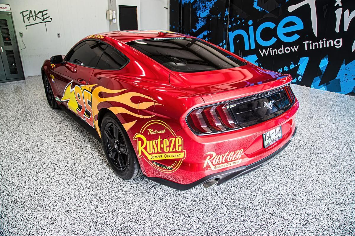 Red sports car in a window tinting shop with epoxy garage floor