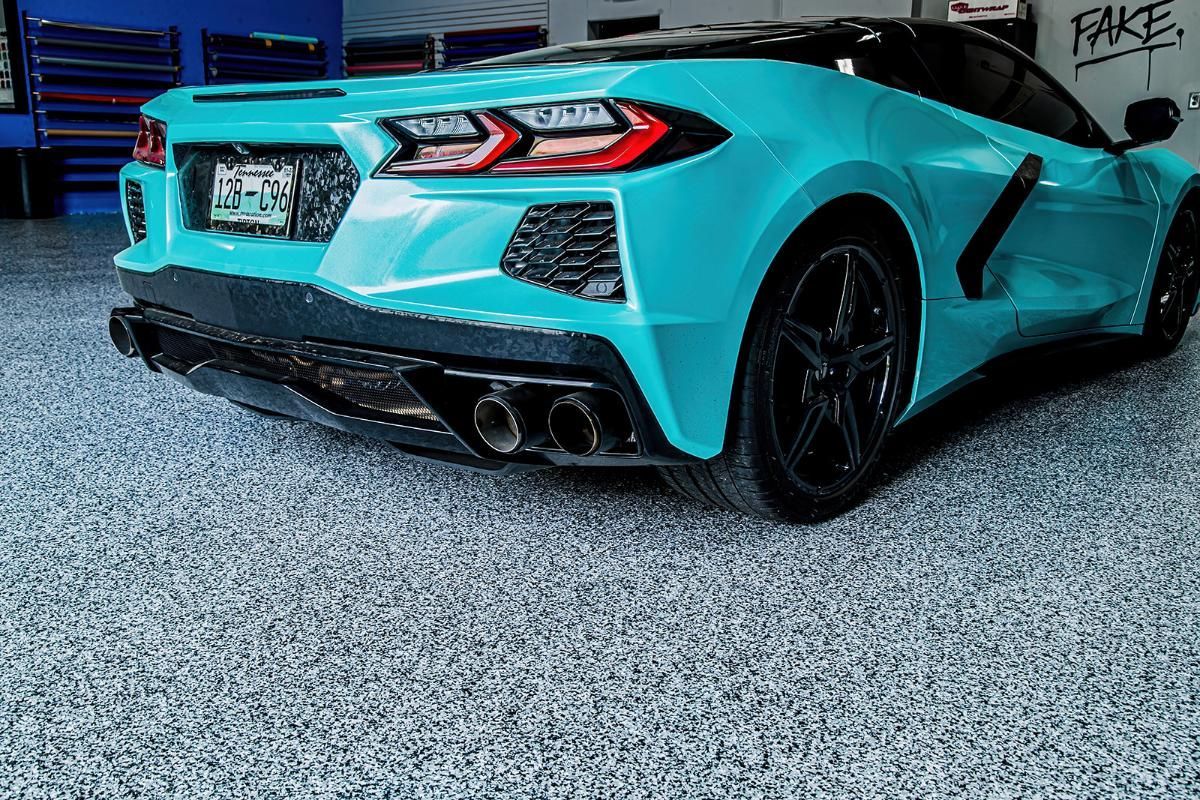 Blue sports car in a window tinting shop with epoxy garage floor