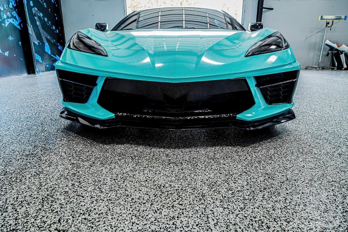 Blue sports car in a window tinting shop with epoxy garage floor