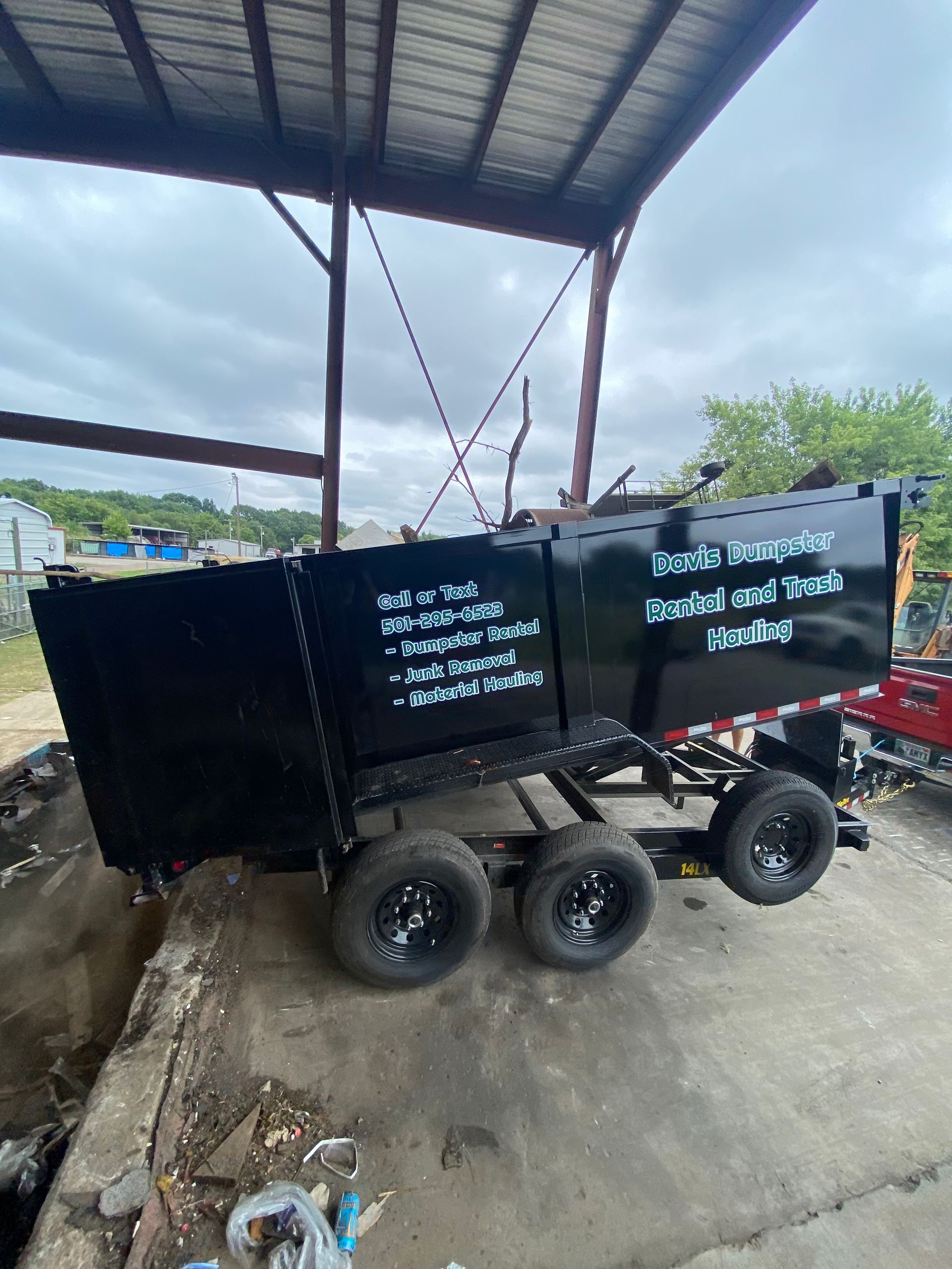 Black trailer with triple wheels, labeled 