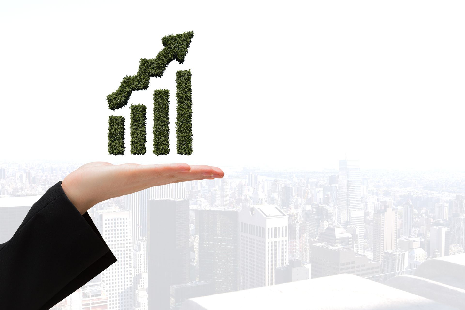 Hand holding a green, growing graph over a blurred cityscape.