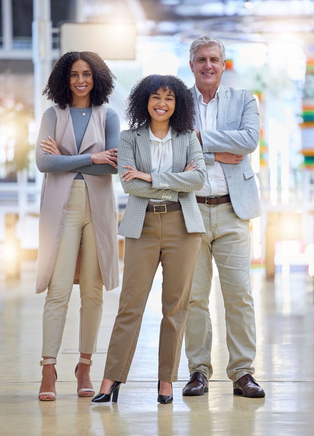 A group of people standing next to each other with their arms crossed.