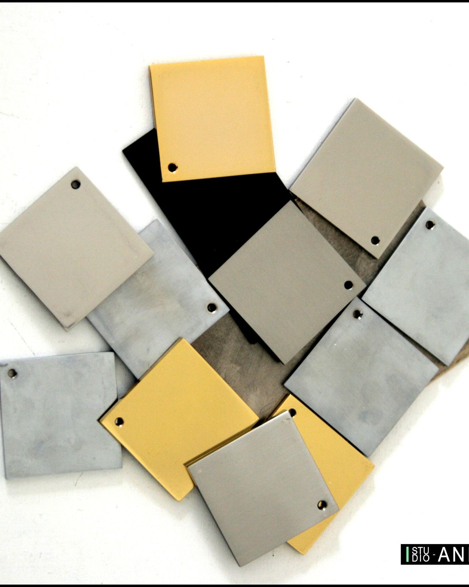 Persone che esaminano progetti architettonici, campioni di colori e campioni di ante di armadi su una scrivania.