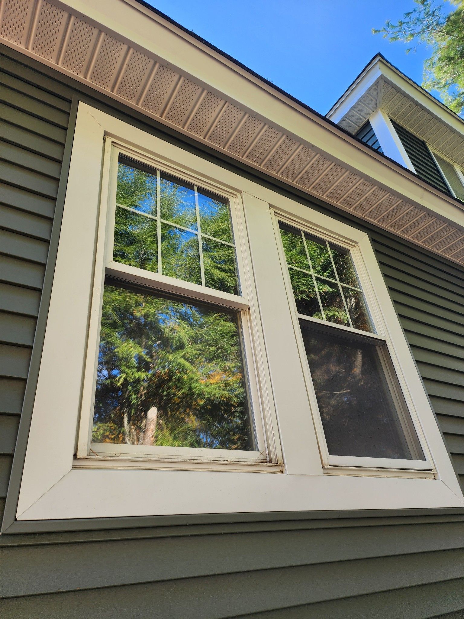 A house with two windows on the side of it