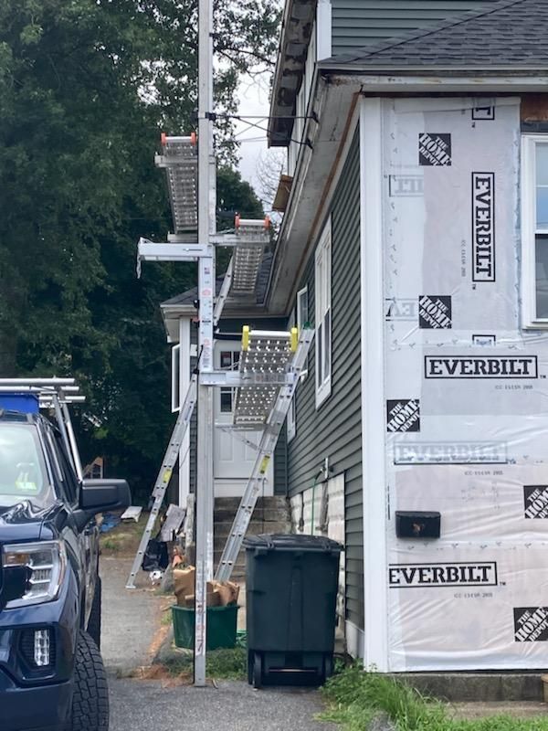 A truck is parked in front of a house that is being remodeled.