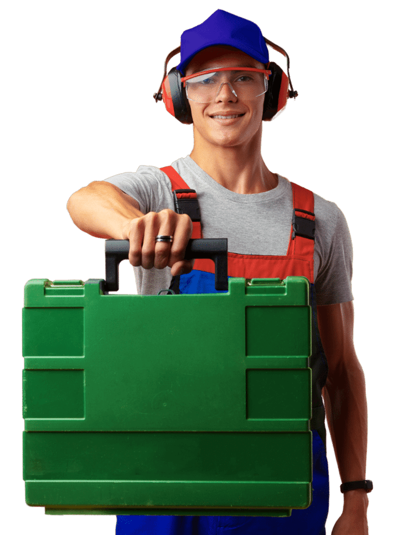 A man wearing headphones and goggles is holding a green toolbox.