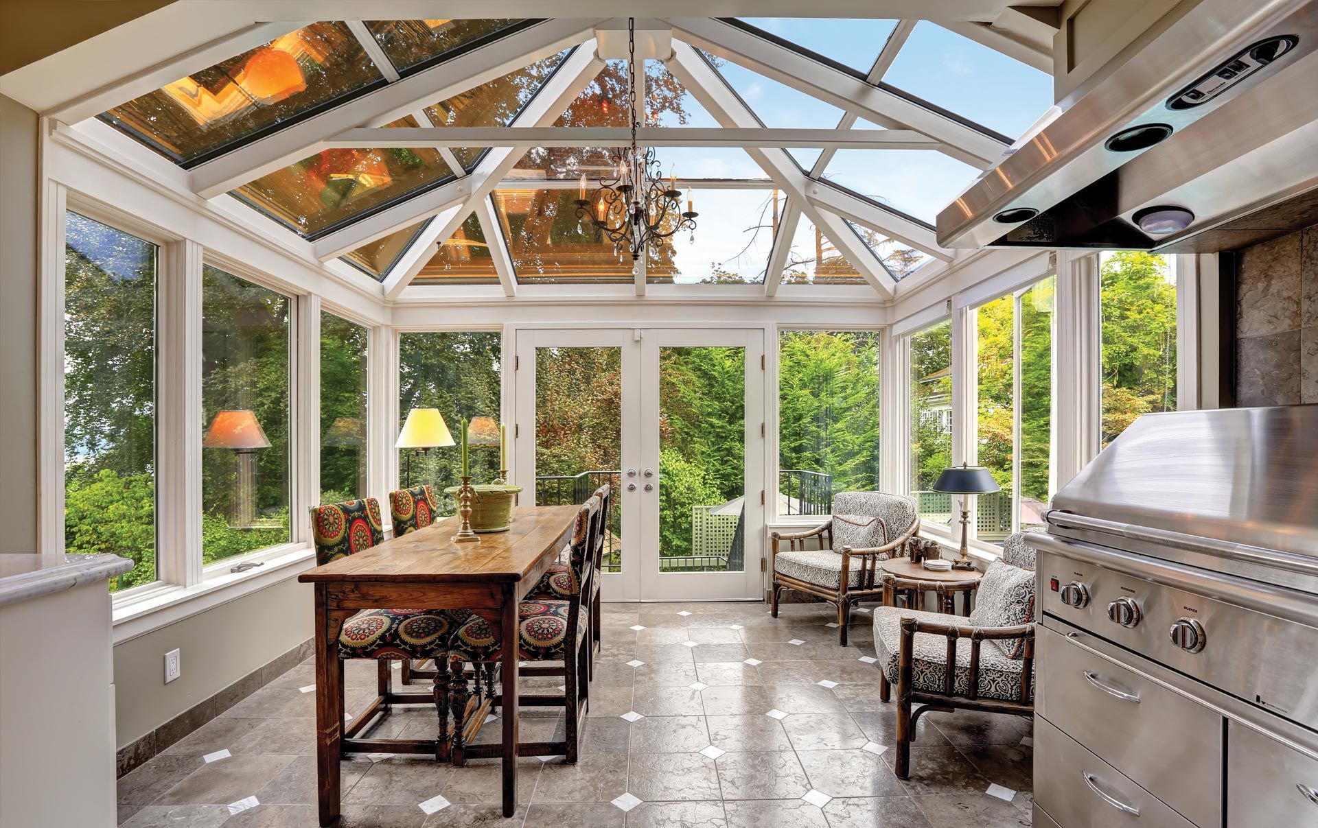 A sunroom with a table and chairs and a grill.