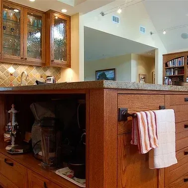 A kitchen with a towel hanging from a towel rack