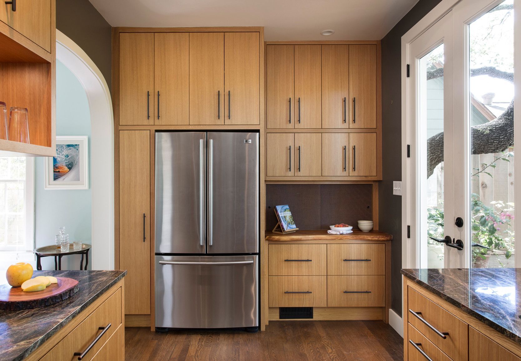 A kitchen with stainless steel appliances and wooden cabinets.