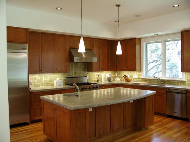 A kitchen with wooden cabinets and stainless steel appliances