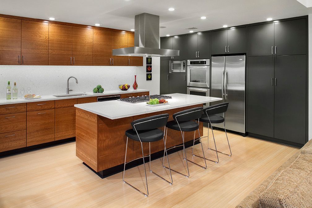 A kitchen with stainless steel appliances and wooden cabinets