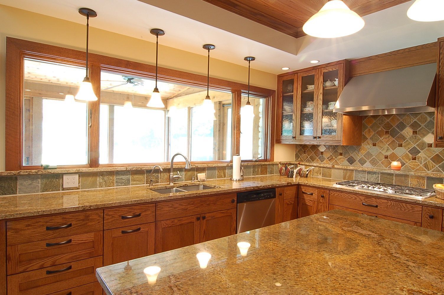A kitchen with granite counter tops and wooden cabinets