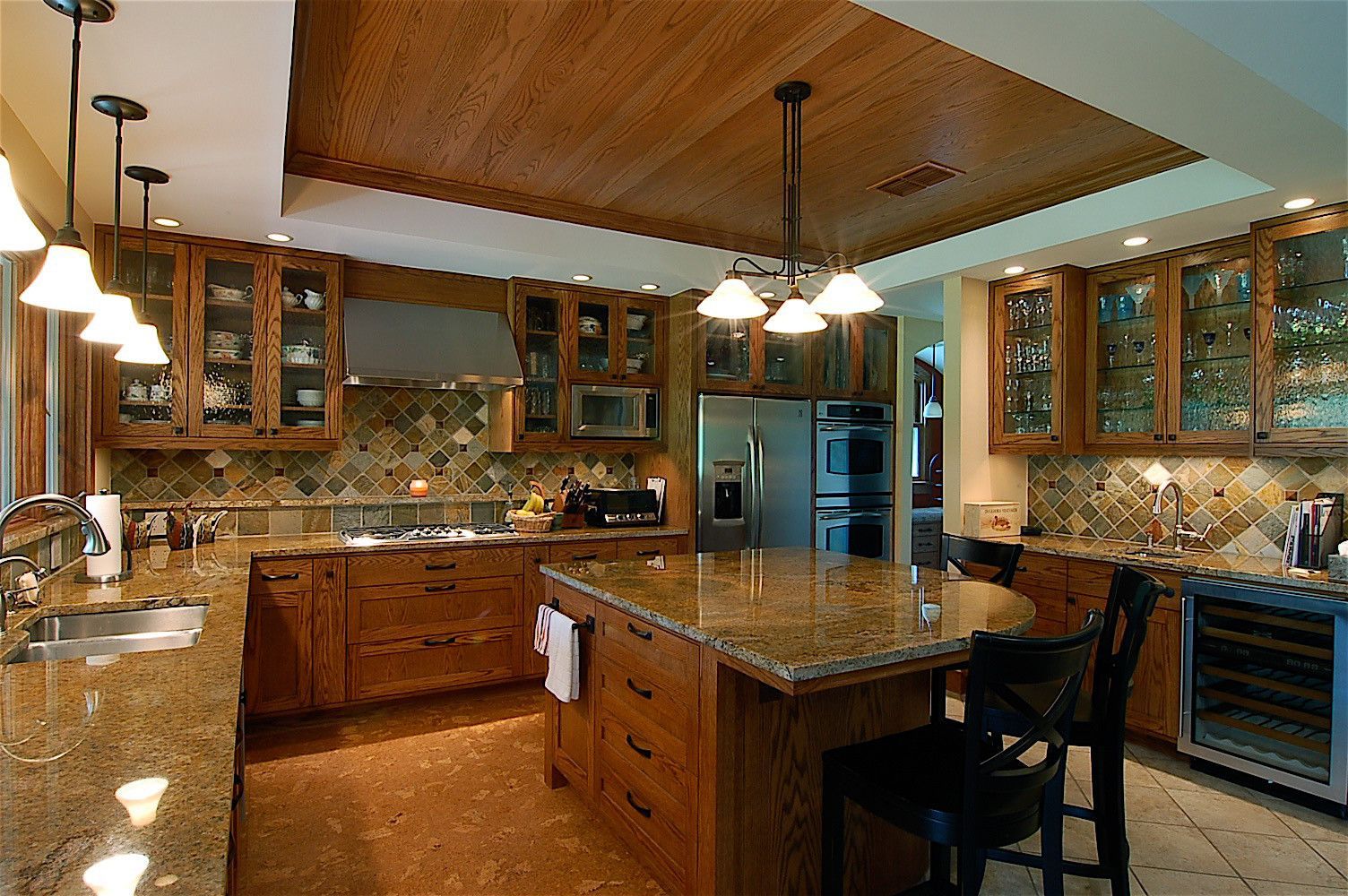 A kitchen with wooden cabinets and granite counter tops