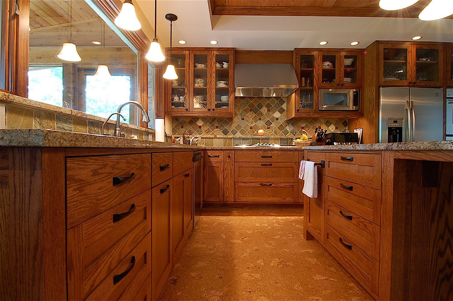 A kitchen with wooden cabinets and granite counter tops