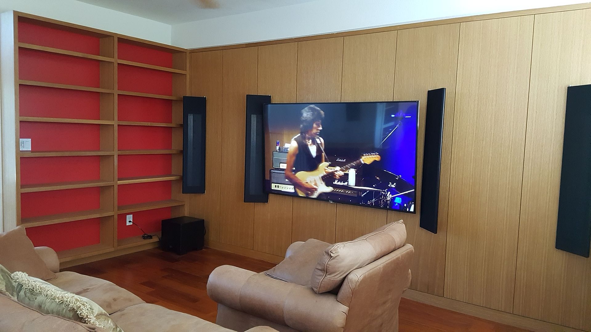 A living room with a large flat screen tv on the wall.